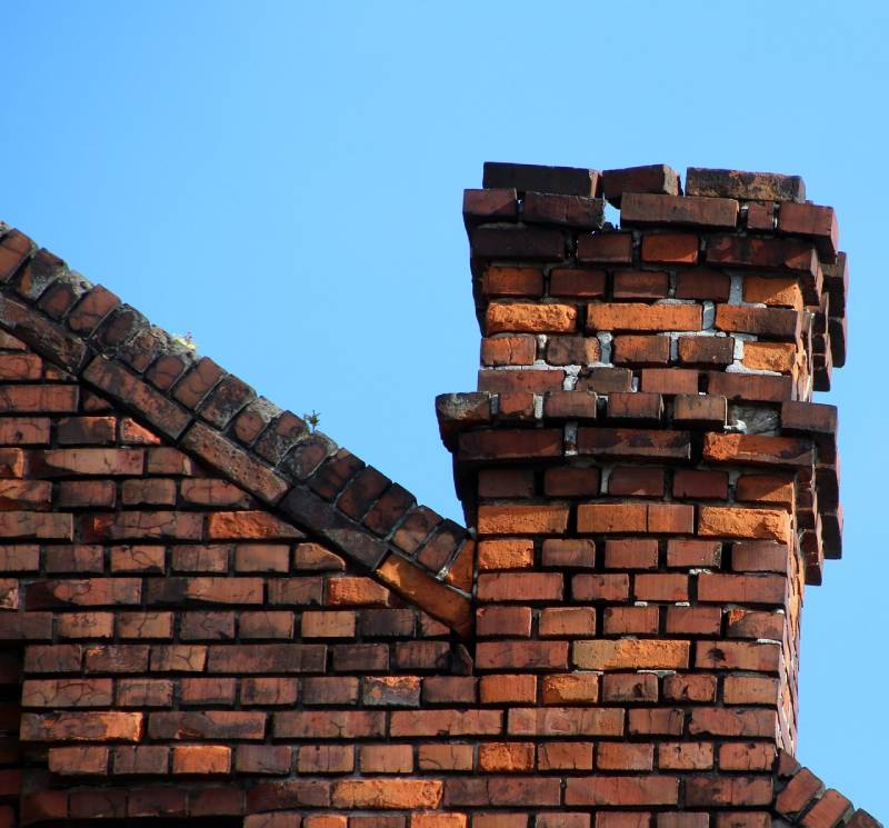Signs Your Ray Home Needs a Chimney Inspection Damaged chimney on an Ray home showing cracks and missing mortar
